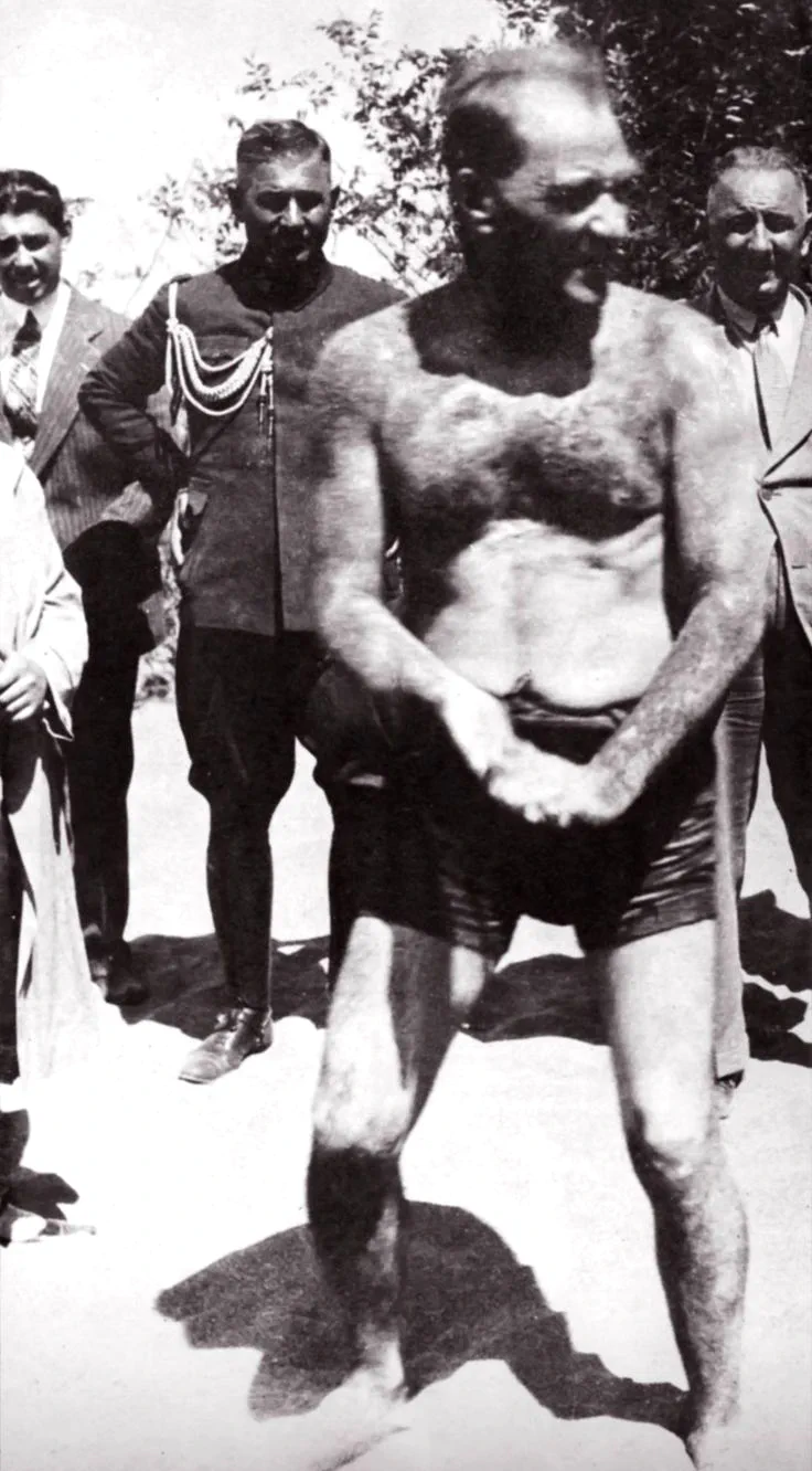 Atatürk gioca sulla sabbia mentre i suoi colleghi lo osservano, anni ‘30